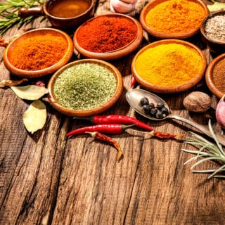 Various herbs and spices on wooden table
