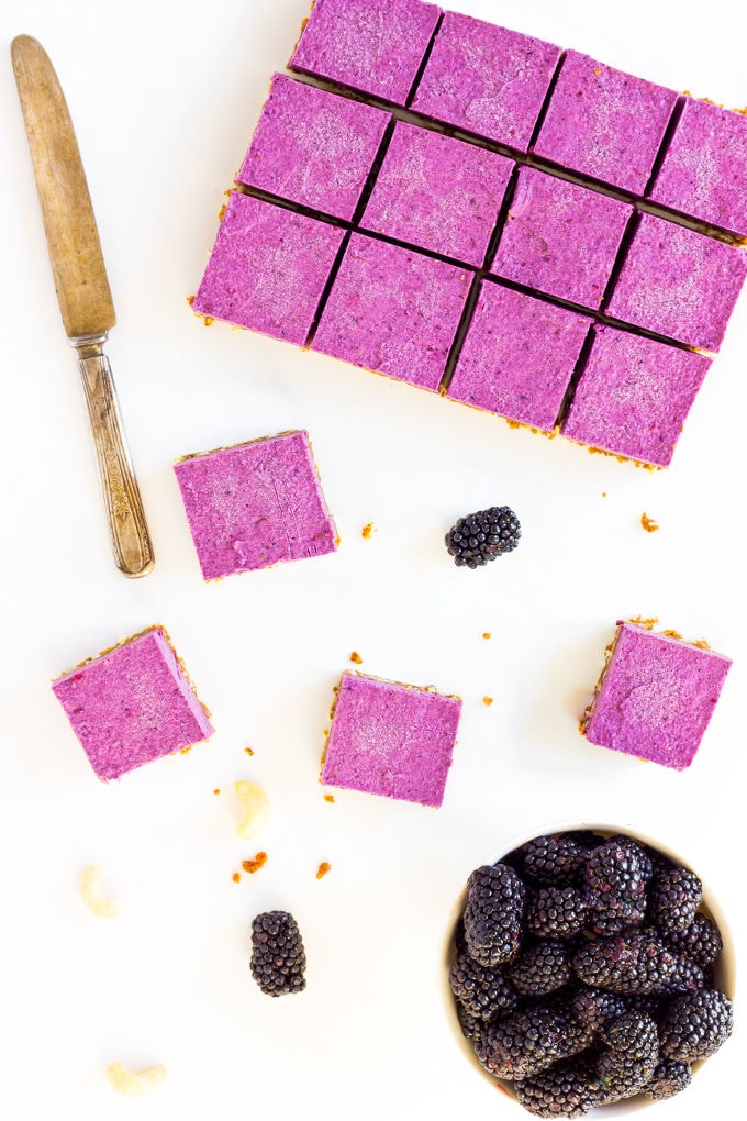 These Raw Vegan BlackBerry Cheesecake bars are super creamy and perfectly sweet. This easy no-bake dessert is also extremely healthy! You would never believe it's dessert by simply looking at the nutritional values. This recipe is also Paleo, Gluten-free, Egg-free, Flourless and Dairy-Free! | www.onecleverchef.com