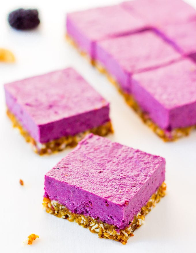 These Raw Vegan BlackBerry Cheesecake bars are super creamy and perfectly sweet. This easy no-bake dessert is also extremely healthy! You would never believe it's dessert by simply looking at the nutritional values. This recipe is also Paleo, Gluten-free, Egg-free, Flourless and Dairy-Free! | www.onecleverchef.com