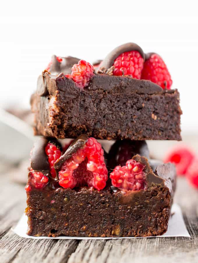 These healthy Raspberry and Chocolate Protein Brownies are deliciously moist and extra rich. Naturally sweetened, this melt in your mouth protein snack is the perfect post-workout treat. Made with dates and almond flour, this guilt-free, decadent dessert is also paleo, vegan, gluten-free, dairy-free, egg-free and flourless.