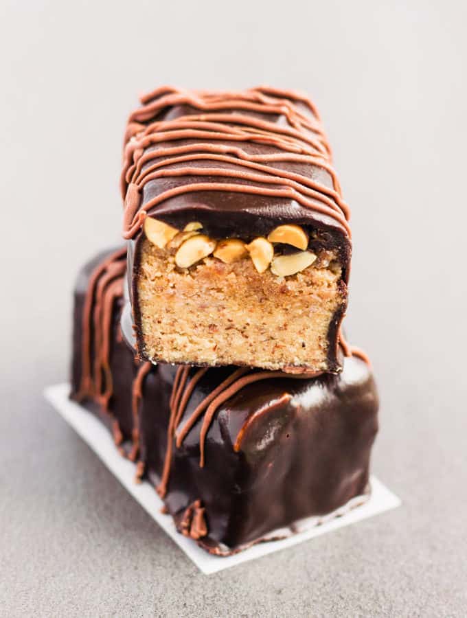 These healthy snickers proteins bars are a homemade copycat of the original bar which taste just like it. Made with 100% real food, guilt-free ingredients, this delicious protein snack is gluten-free, paleo, vegan, dairy-free, egg-free, flourless and kid-friendly! www.onecleverchef.com