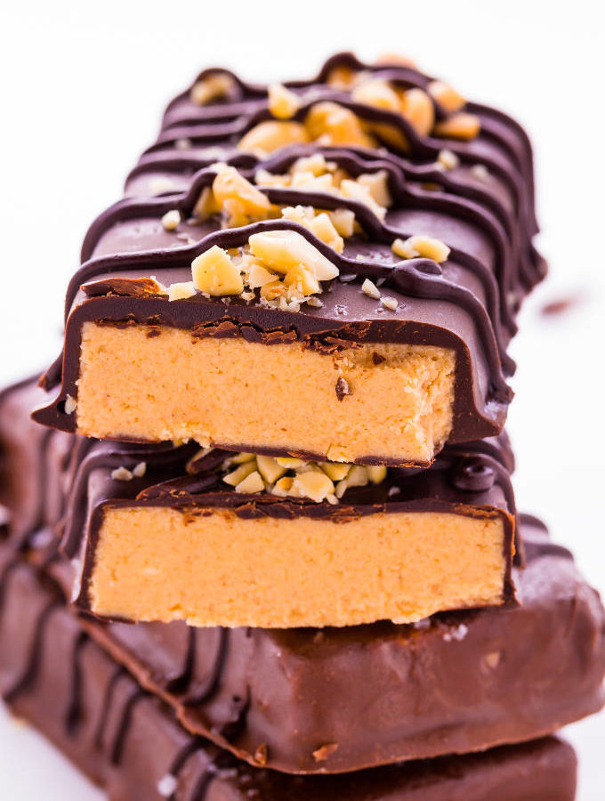 4 chocolate peanut butter protein bars stacked.