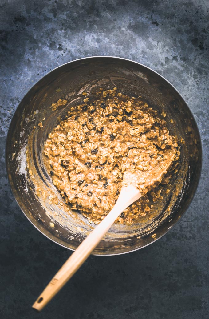 Ingredients for oatmeal raisin protein cookies mixed in a large mixing bowl