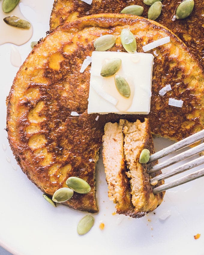 Two bites of Pumpkin Protein Pancakes planted on a fork