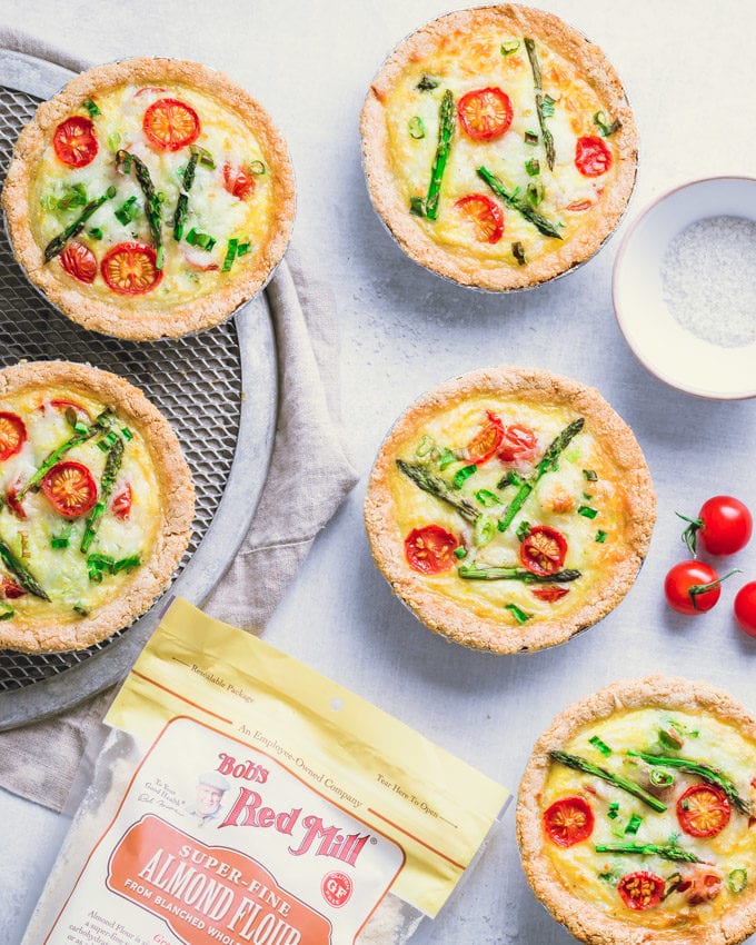 Tomato asparagus small quiches on a gray surface