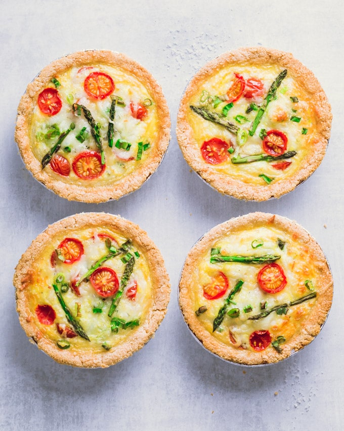 Tomato asparagus small quiches on a gray surface